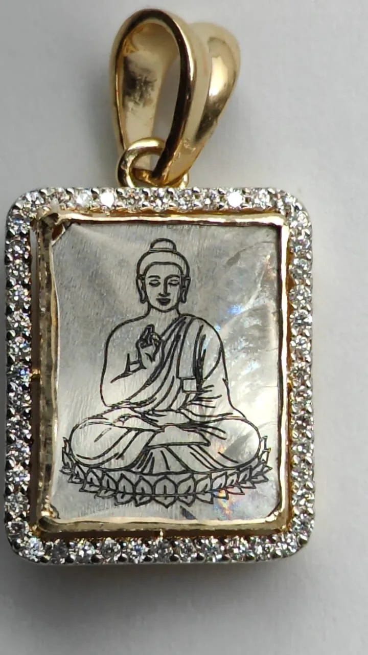 Buddha engraved on a diamond set in a gold pendant